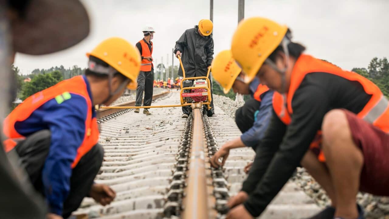 workers from China Railway No.2 Engineering Group screw the welded seamless rails of the China-Laos railway in the northern suburb of Vientiane, Laos (Kaikeo Saiyasane - Xinhua via Getty)