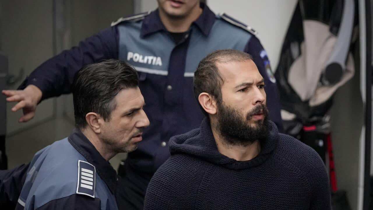 Police officers escort Andrew Tate handcuffed to his brother Tristan Tate, to the Court of Appeal in Bucharest, Romania, on 27 February 2023.