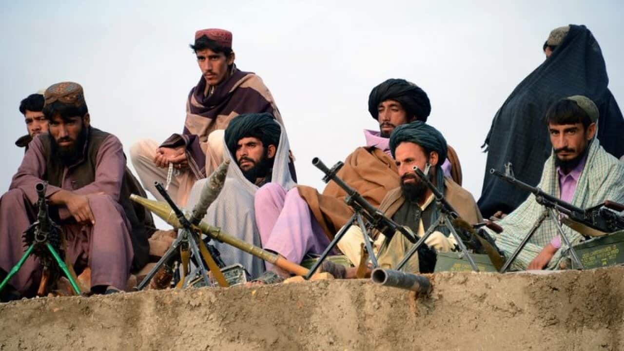 In this photograph taken on November 3, 2015, Afghan Taliban fighters listen to Mullah Mohammad Rasool Akhund.