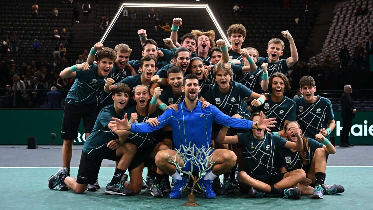 Novak Djokovic from Serbia celebrates his record-extending 40th masters title with ball kids at the 2023 Rolex Paris Masters on November 5, 2023