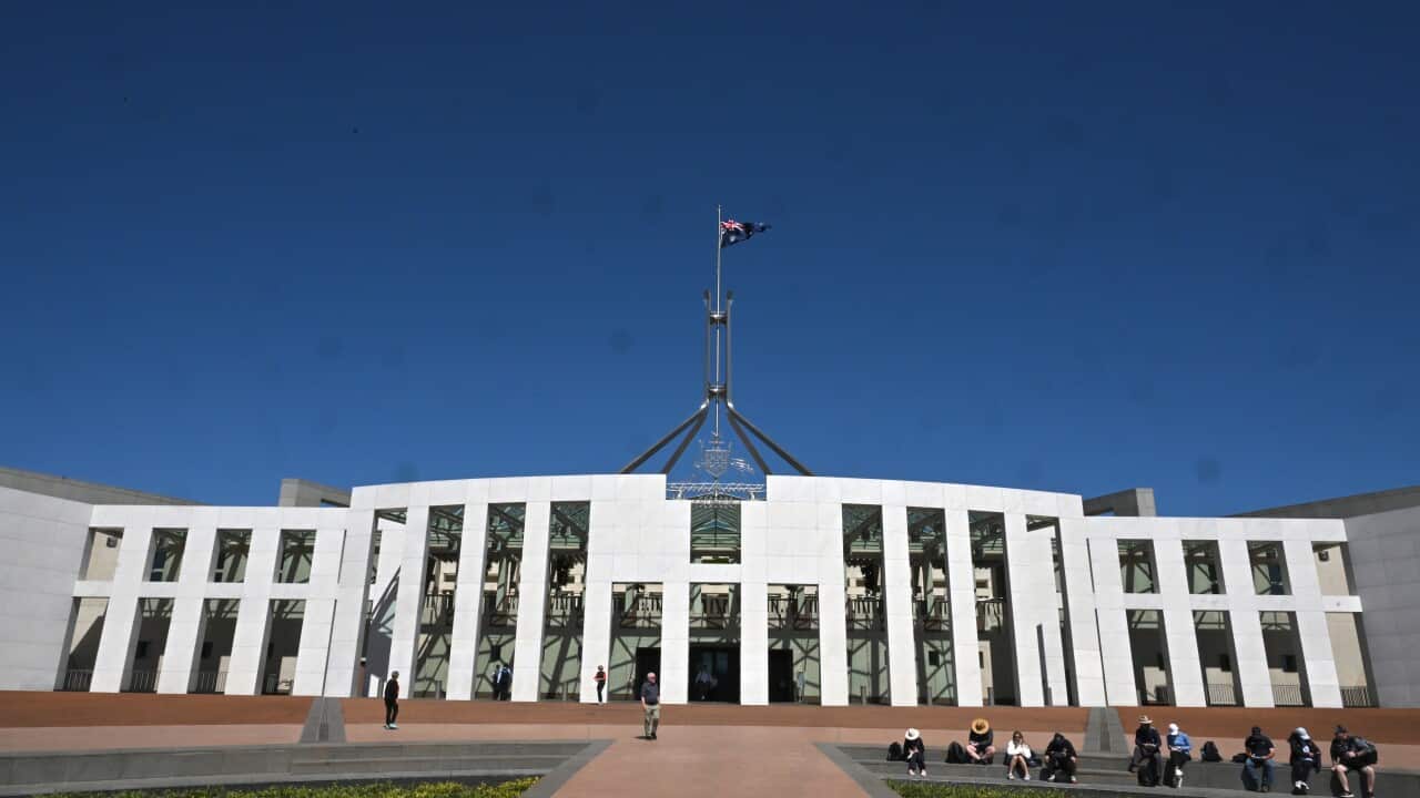 Australian Parliament House in Canberra, with the national flag flying above the building.