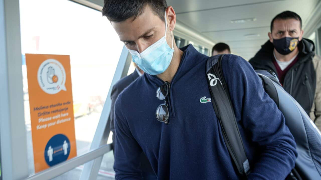 Novak Djokovic looks as his documents after landing in Belgrade, Serbia following his deportation from Australia.