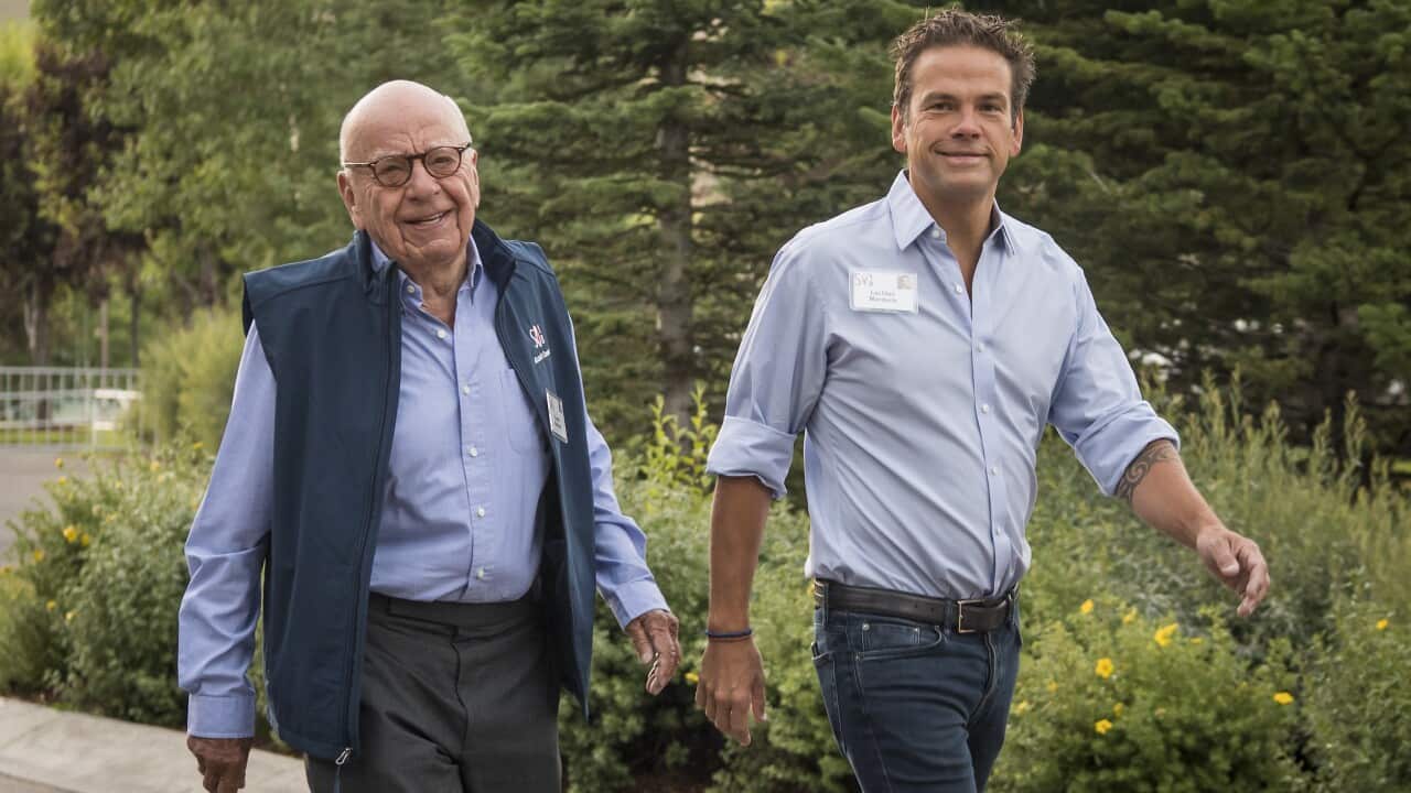Lachlan and Rupert Murdoch walking together.