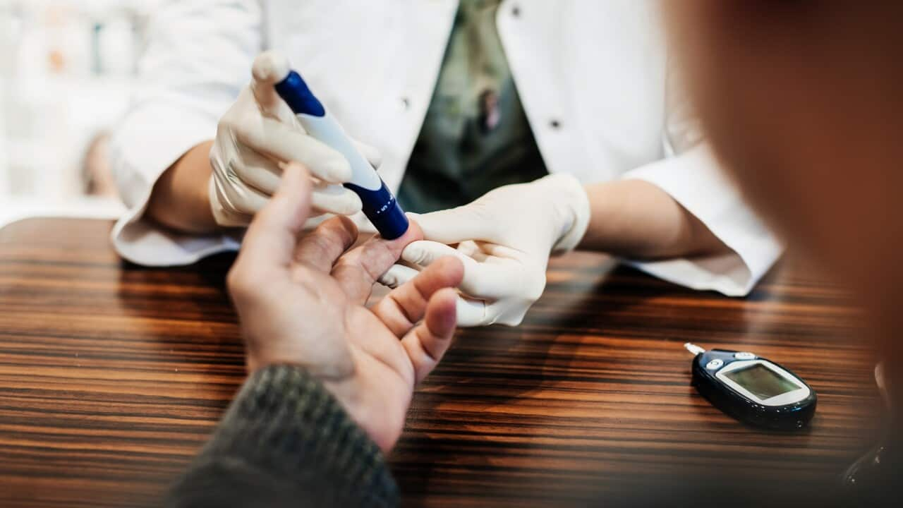 Pharmacist Checking Customer's Blood Sugar Levels