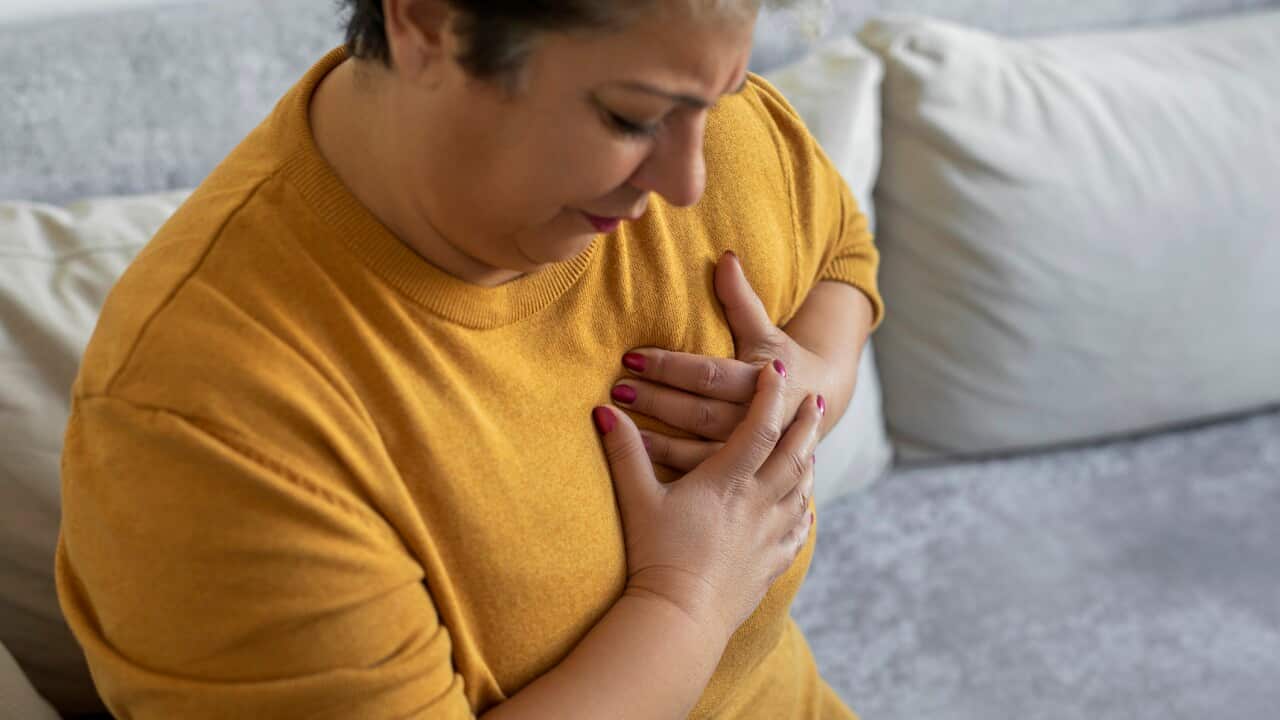 Woman painful grimace pressing the upper abdomen