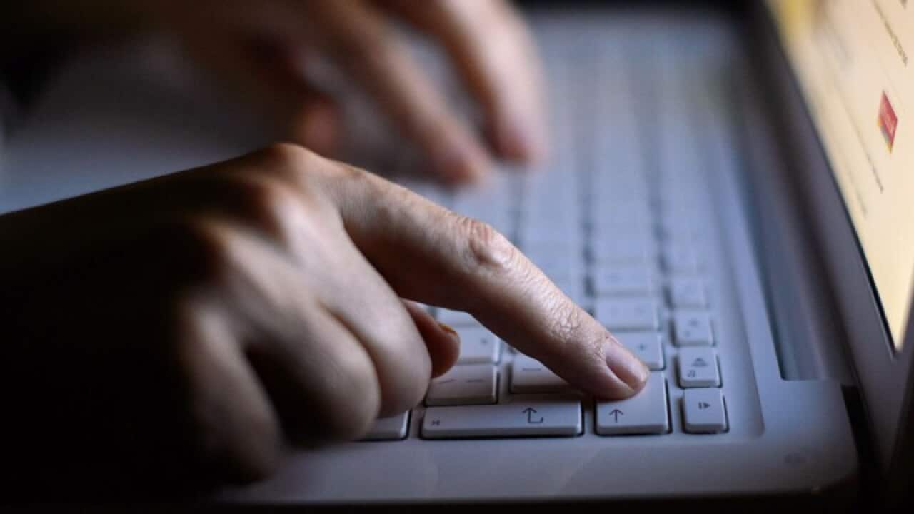 A woman's hands using a laptop keyboard