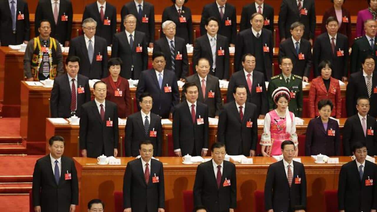 Government officials and delegates stand for the national anthem during the opening of the fourth Session of the 12th National People's Congress (NPC) (EPA)