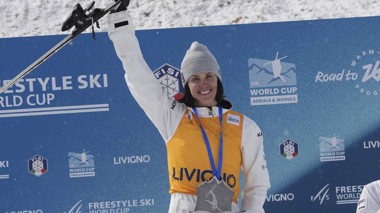 A woman lifting a trophy.