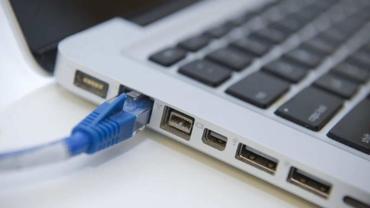 An ethernet cable is connected to a laptop computer.