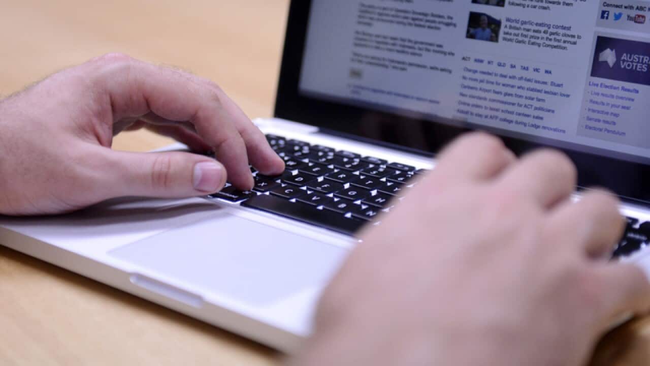 A man uses a laptop computer