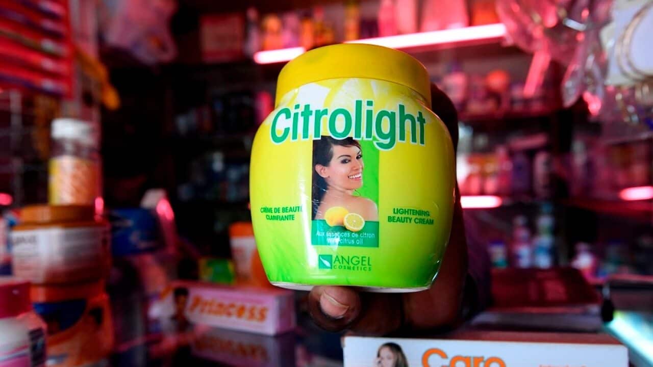 A beautician displays products used for skin lightening at a beauty shop, in Nairobi.