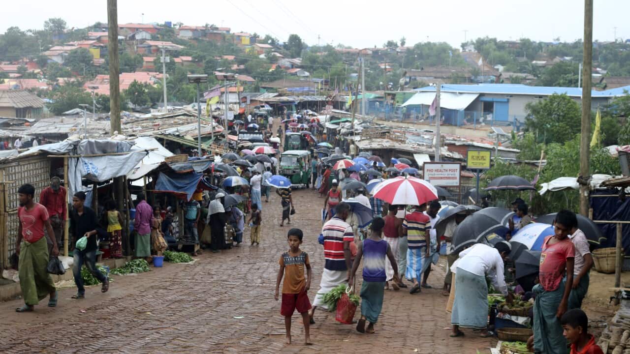 People shop for vegetables at the Kutupalong Rohingya refugee camp in Cox's Bazar, Bangladesh