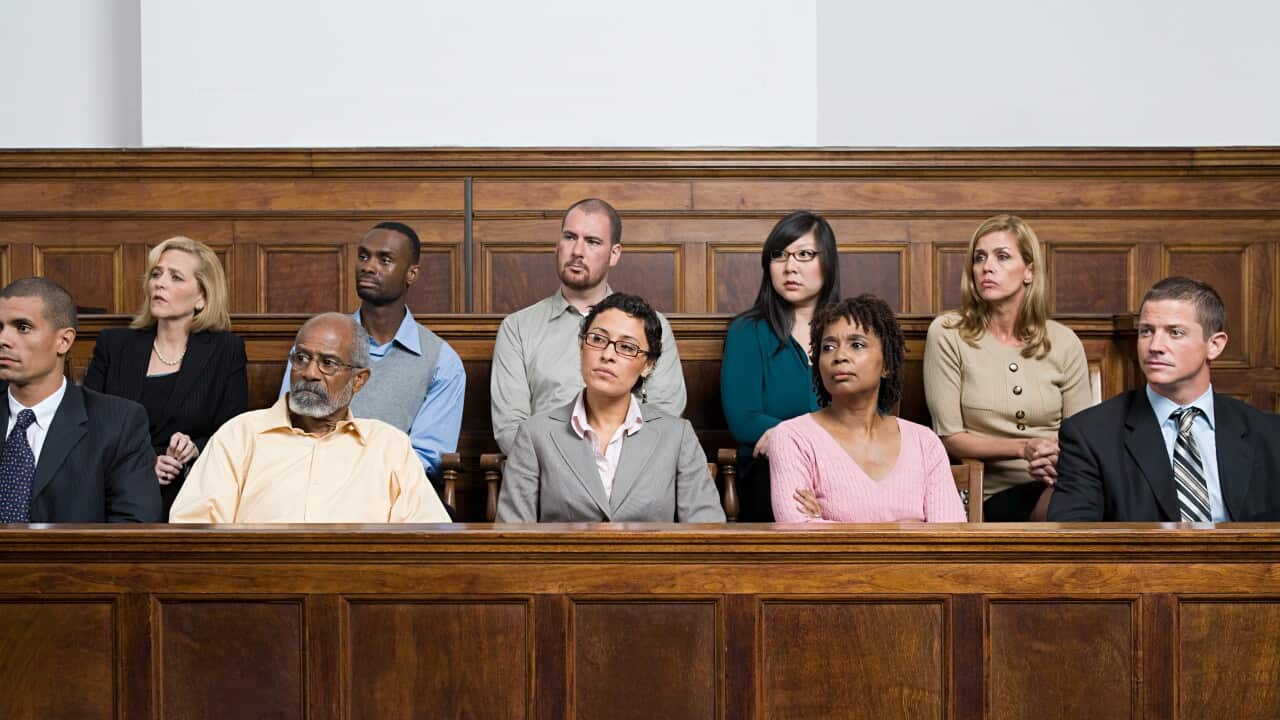 Ten men and women sitting in a jury box.