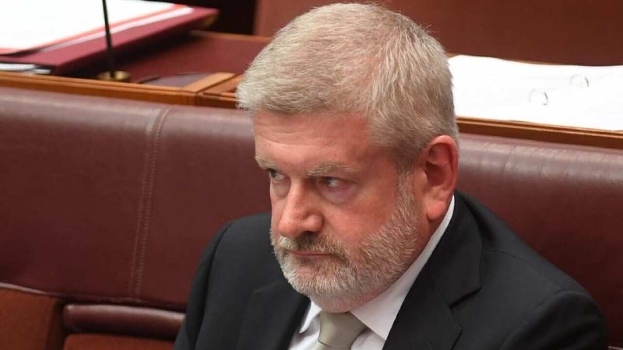 Mitch Fifield reacts during debate in the Senate chamber.