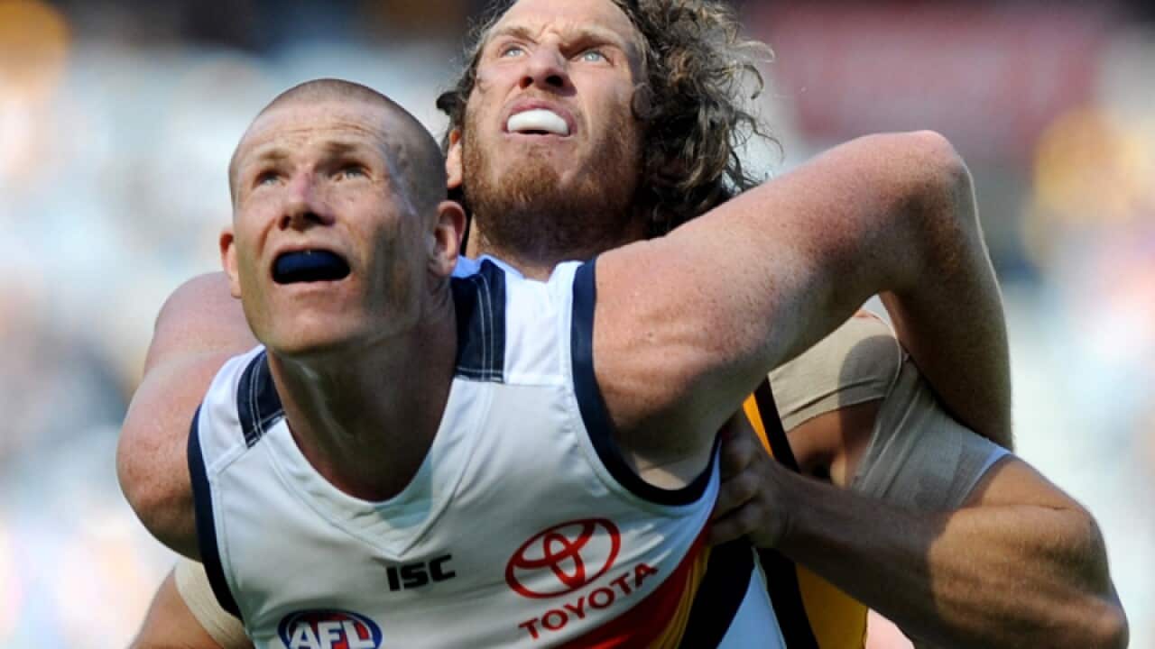 Ty Vickery of the Hawks and Sam Jacobs of the Crows