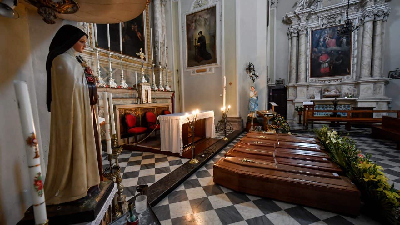 Coffins waiting for transport in the Church of the Holy Trinity Convent in Serina, Italy.