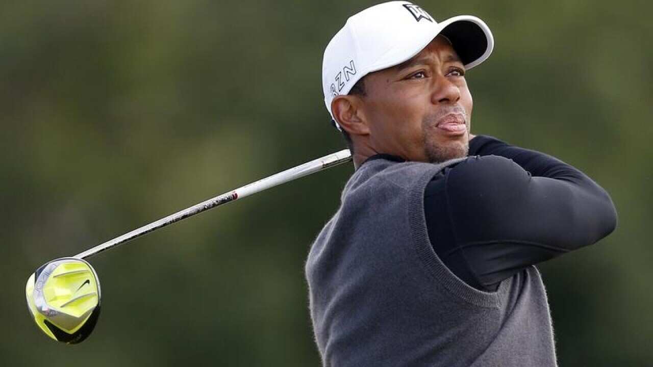 Tiger Woods tees off