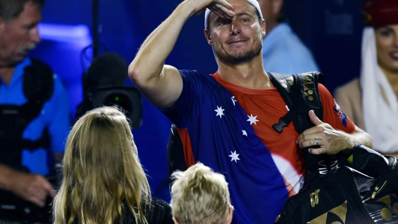 Lleyton Hewitt waves to fans as he leaves after losing his match