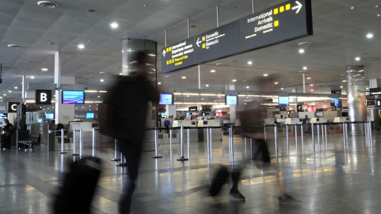 Airline passengers make their way through Melbourne Airport.