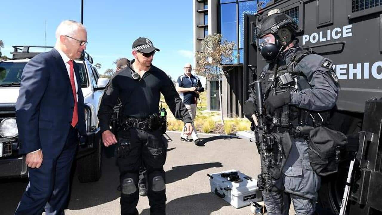 Australian Prime Minister Malcolm Turnbull speaks to members of a Tactical Response Team (TRT) during a tour of the AFP Forensics Facility (AAP)