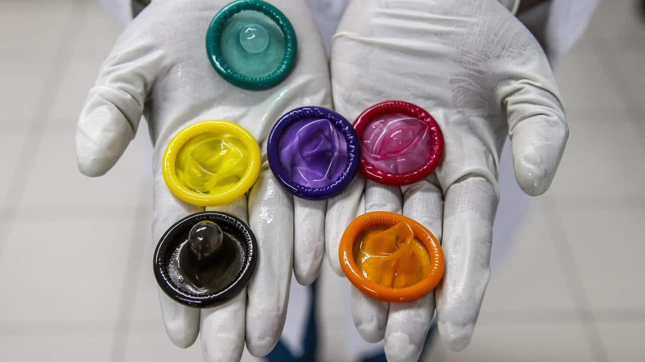 A variety of coloured condoms.