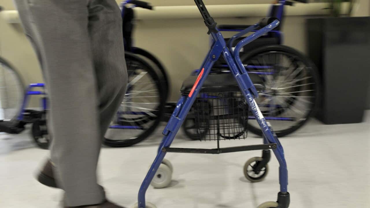A man uses a walker to assist his mobility