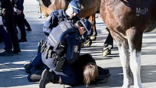 Police arrest a protester during an attempted blockade