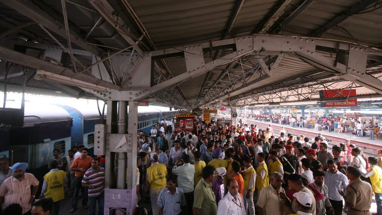 A large group of people crowded together on a train platform.