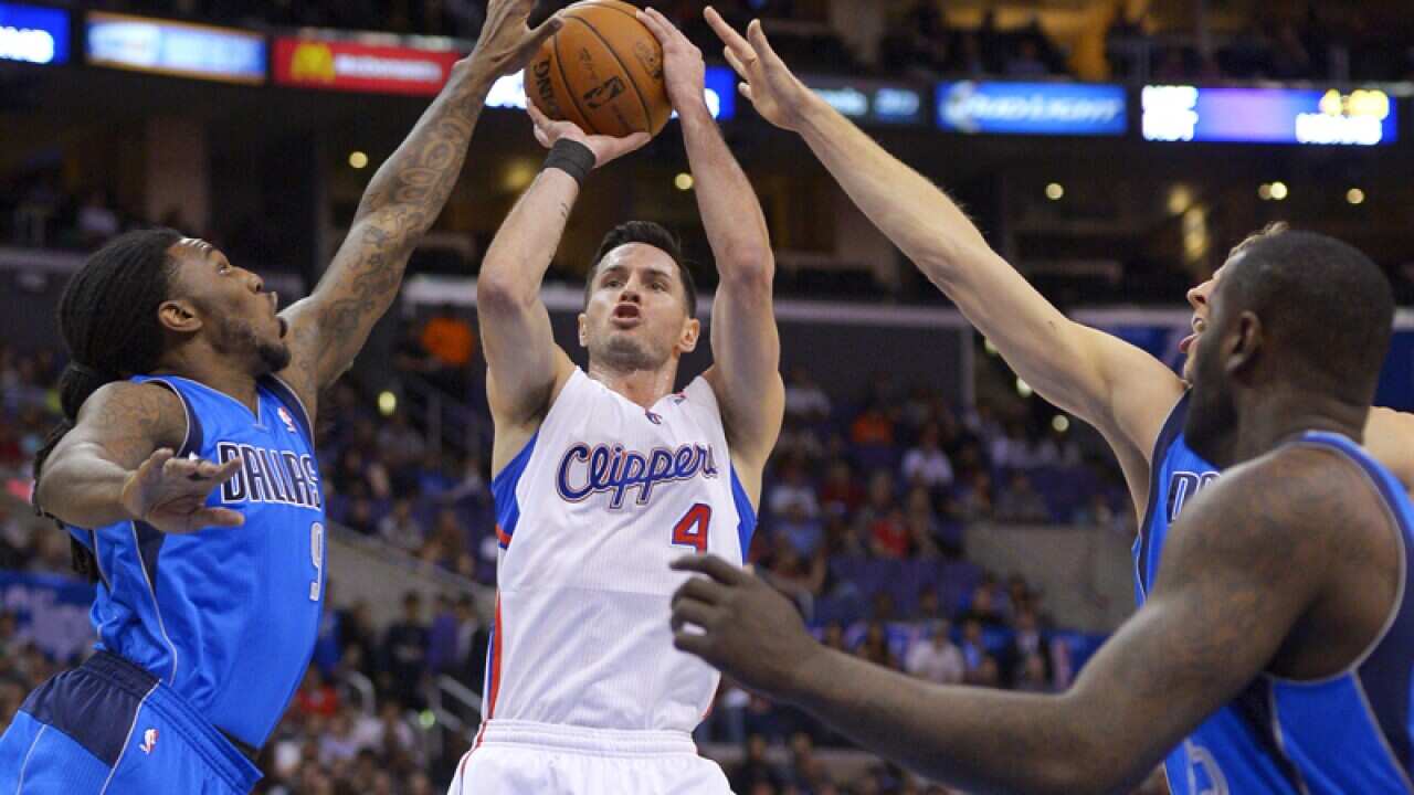 JJ Redick (2L) attempts a shot