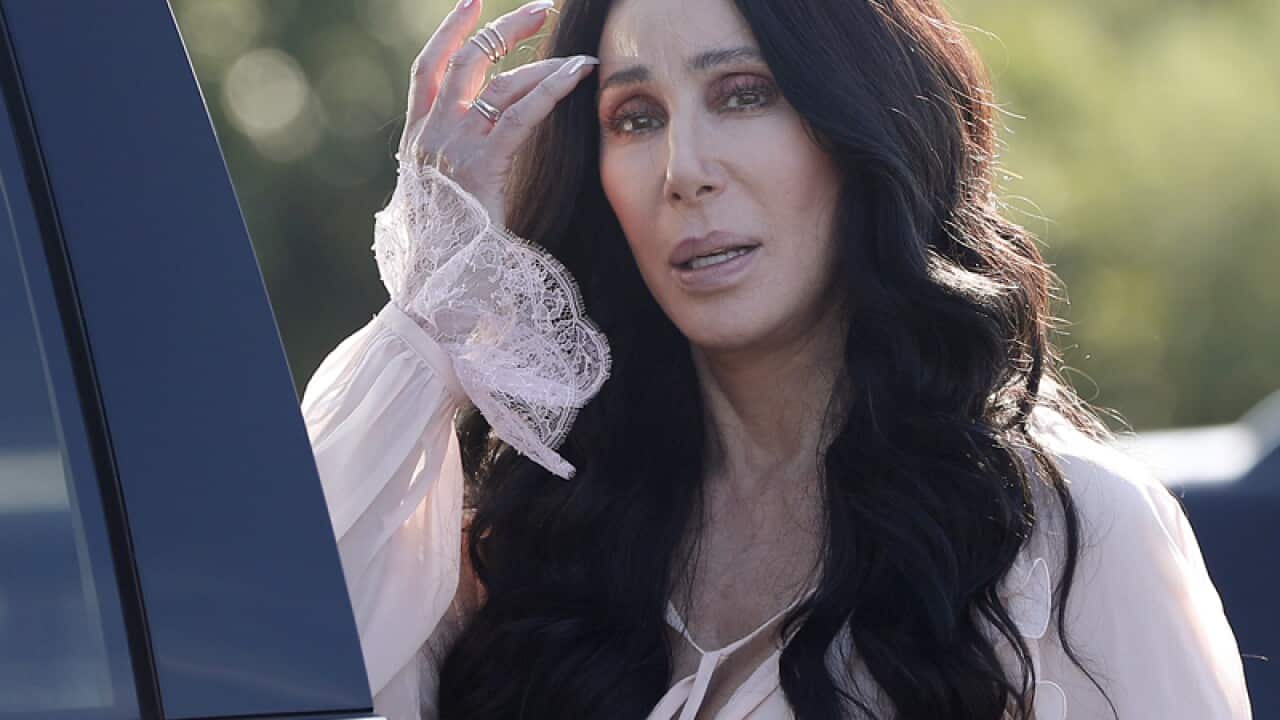 Singer and actress Cher stops to talk to media