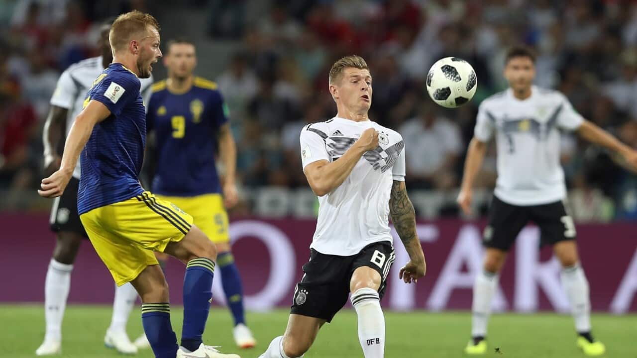 Sebastian Larsson of Sweden (L) and Toni Kroos of Germany in action 