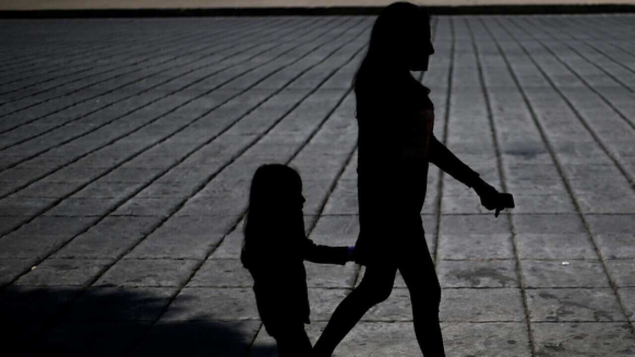 A woman and child attend a march against human trafficking and slavery in Mexico City