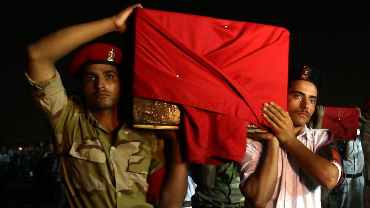 Egyptian soldiers carry the coffins of their colleagues.