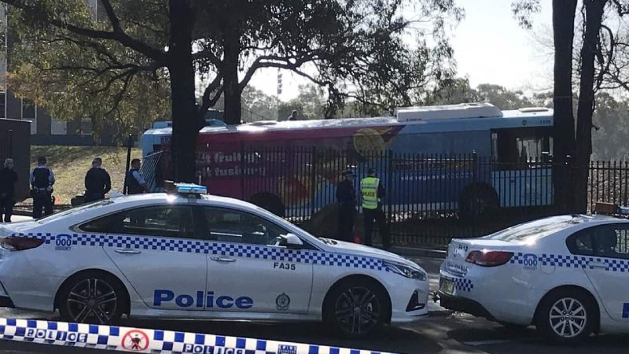 Police are seen working at the site of a bus accident