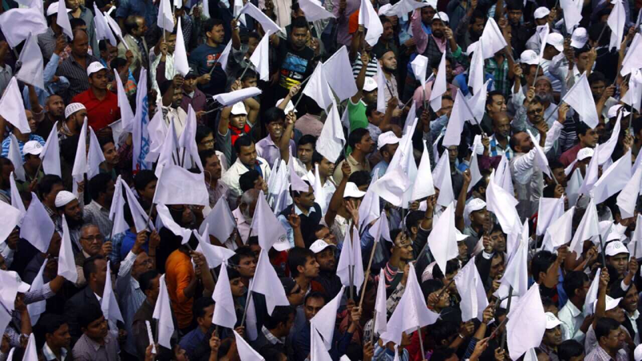 Protesters carry white flags as they march in Bangladesh