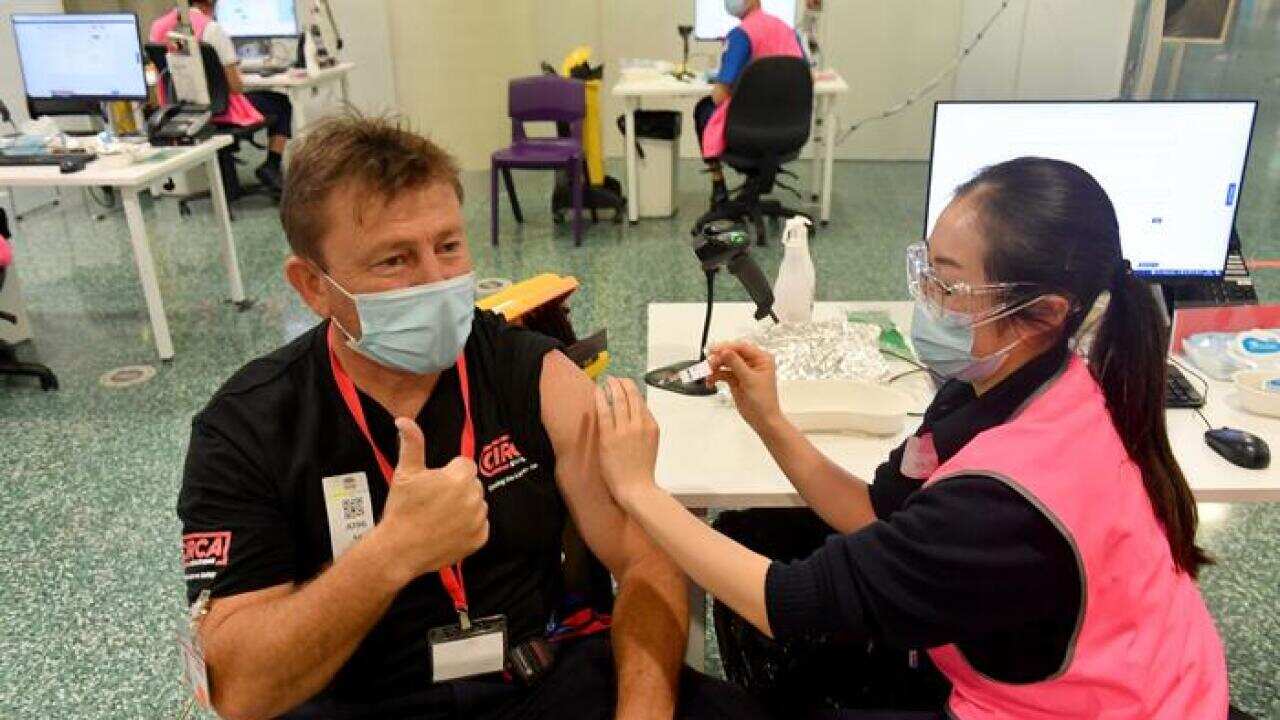 One of the last members of the public receives his booster Pfizer vaccine at Qudos Bank Arena Vaccination Centre before it close in Sydney, Sunday, November 7, 2021. (AAP Image/Mick Tsikas) NO ARCHIVING