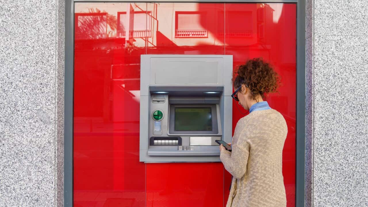 Latin woman using ATM