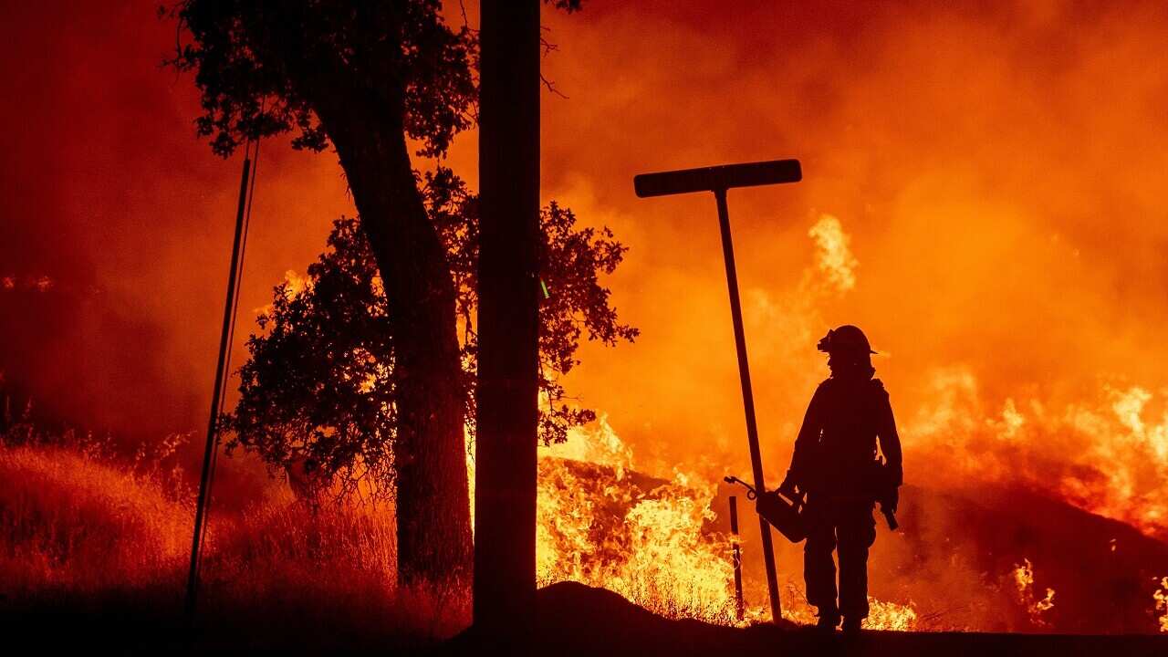 A firefighter lights backfires during the Carr fire in Redding, California on July 27, 2018. 
