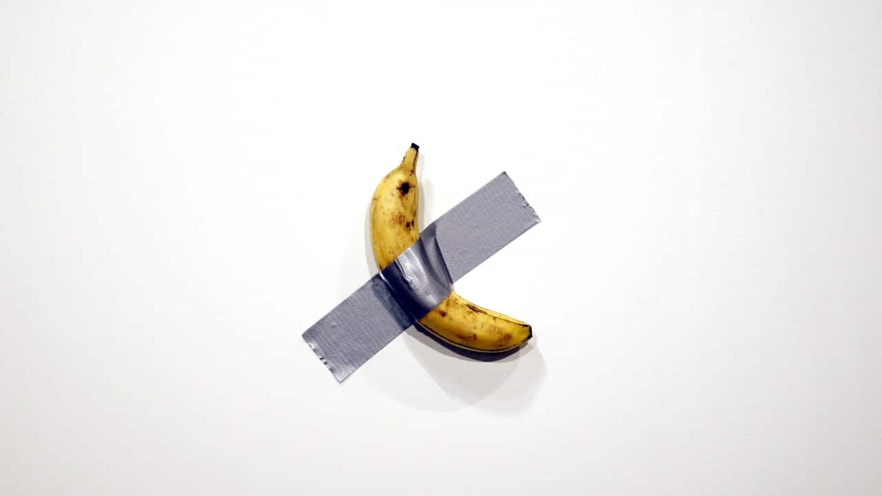 Italian artist Maurizio Cattelan's piece 'Comedian' (a banana duct taped to the wall) is shown during Art Basel in Miami, Florida.