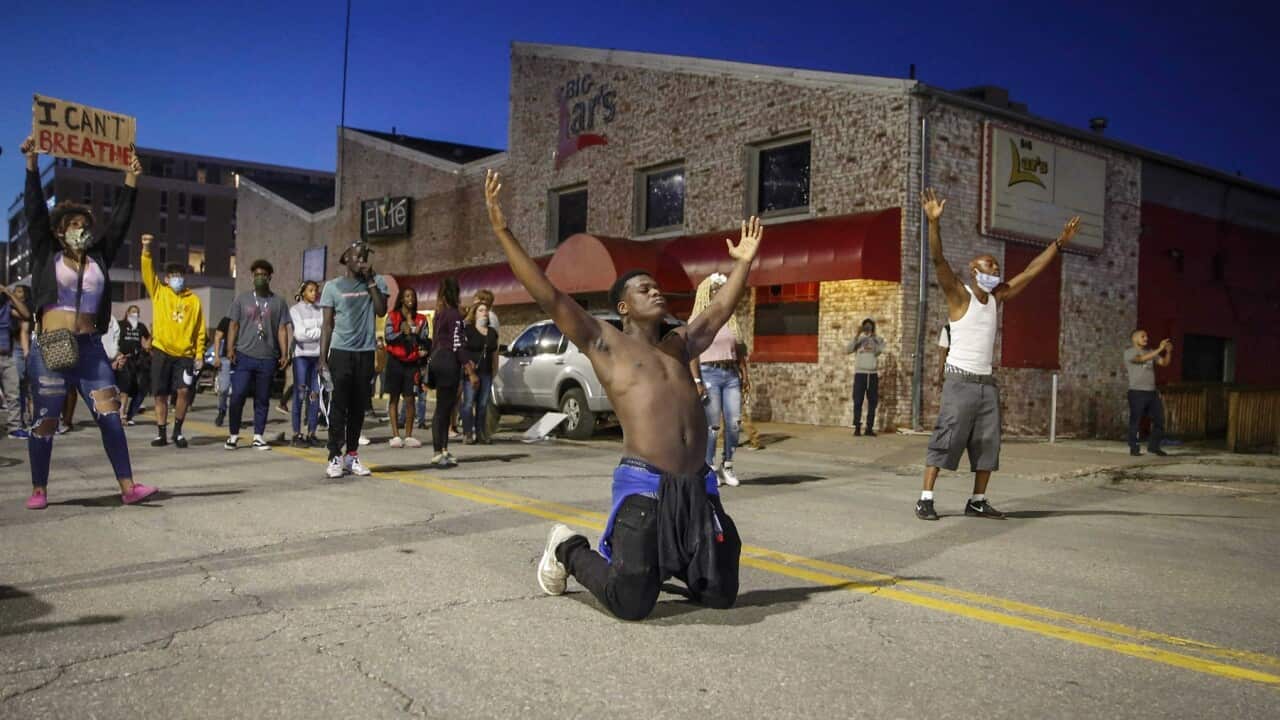 Marcus Lavon of Des Moines Iowa raises his hands during a protest over George Floyd’s death