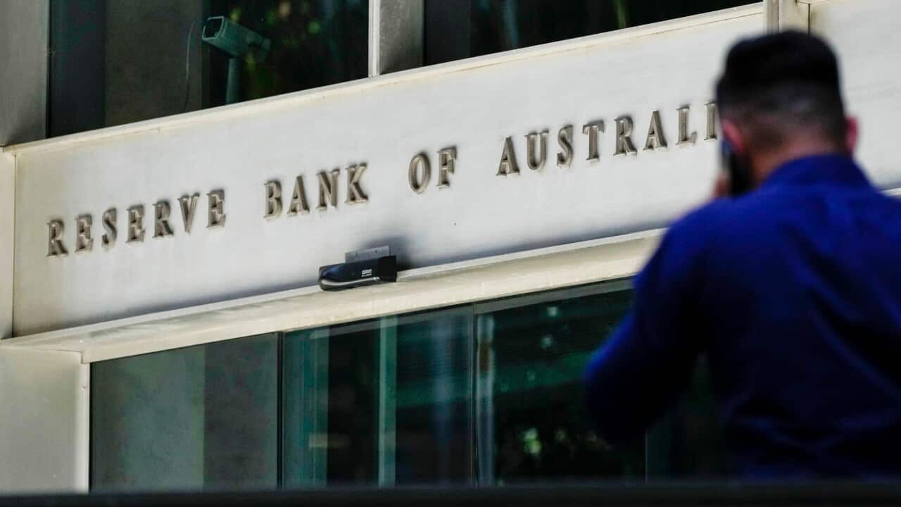 A man walks past the Reserve Bank of Australia building.