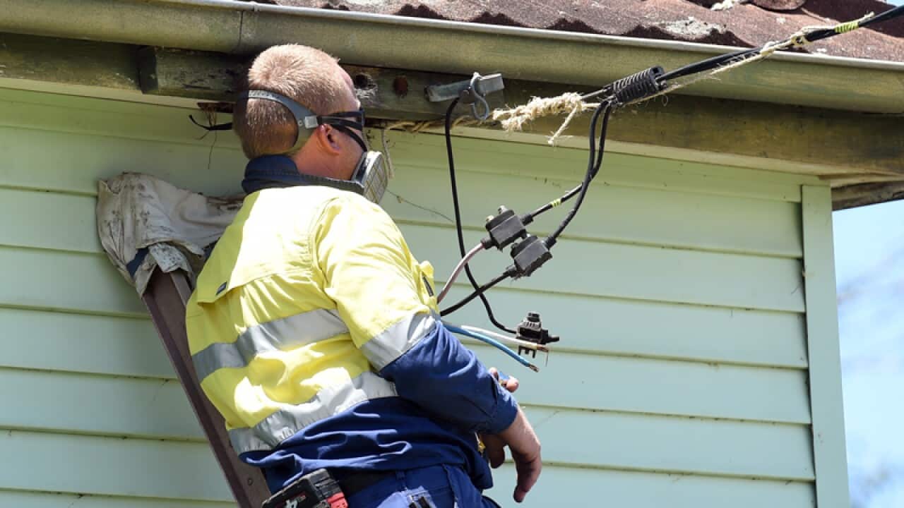 A workman works to restore electricity