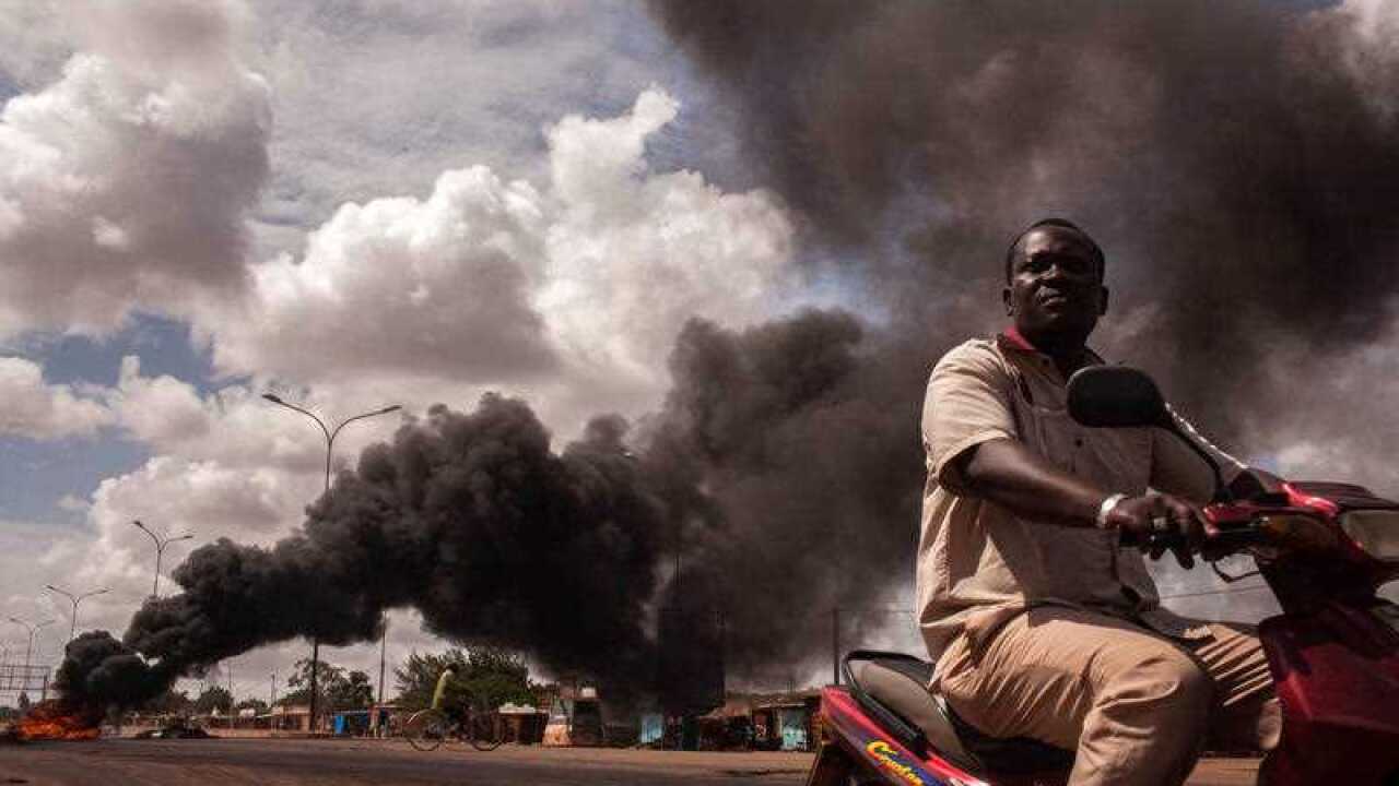 Tires burn, left rear, as people continue protesting against the recent coup in Ouagadougou, Burkina Faso. (AP)