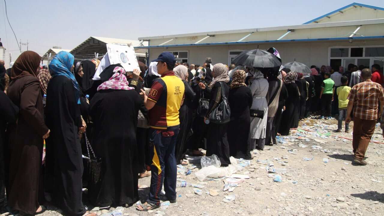 Iraqi displaced families queue at a checkpoint in Erbil, Kurdistan region, north Iraq - AAP.jpg