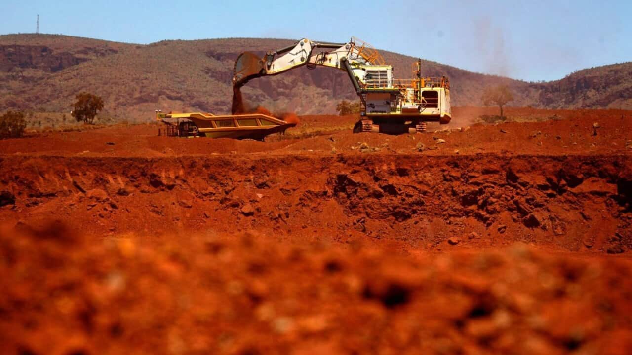A giant excavator loads a mining truck at the Fortescue Solomon iron ore mine located in the Sheila Valley, around 400 km south of Port Hedland, in the Pilbara region of Western Australia December 2, 2013. REUTERS/David Gray