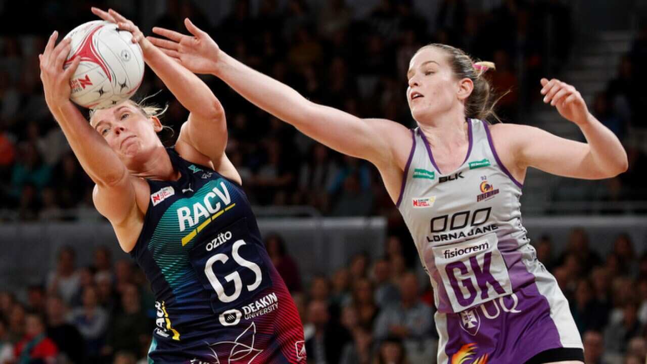 Caitlin Thwaites of the Vixens and Tara Hinchliffe of the Firebirds contest the ball during the Round 1 Super Netball match