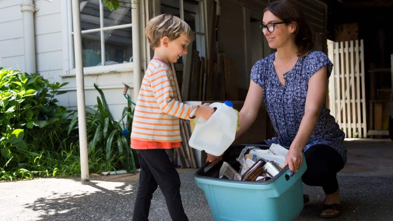 Mother and child sorting bins - Getty Images - Jessie Casson