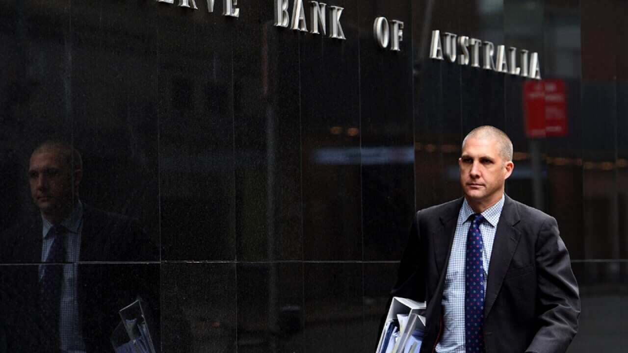 A pedestrian walks past the Reserve Bank of Australia