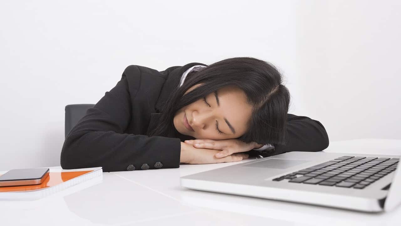 Exhausted businesswoman resting at office desk