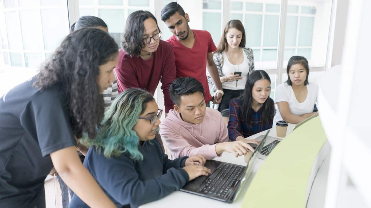 Group of young college students preparing together for final exams